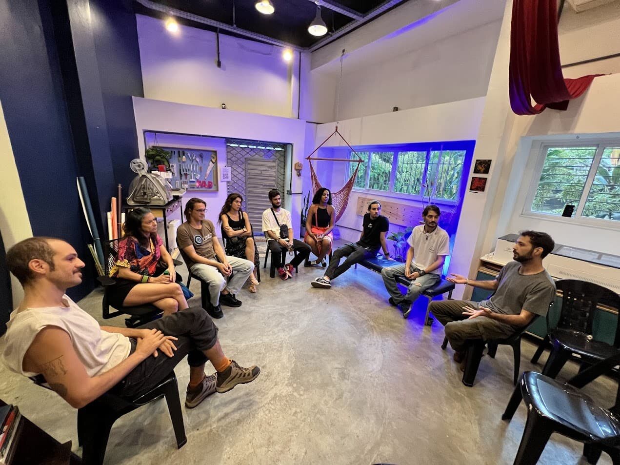Greenpill Brasil community members seated in a discussion circle at a Regen Meetup in Rio de Janeiro.