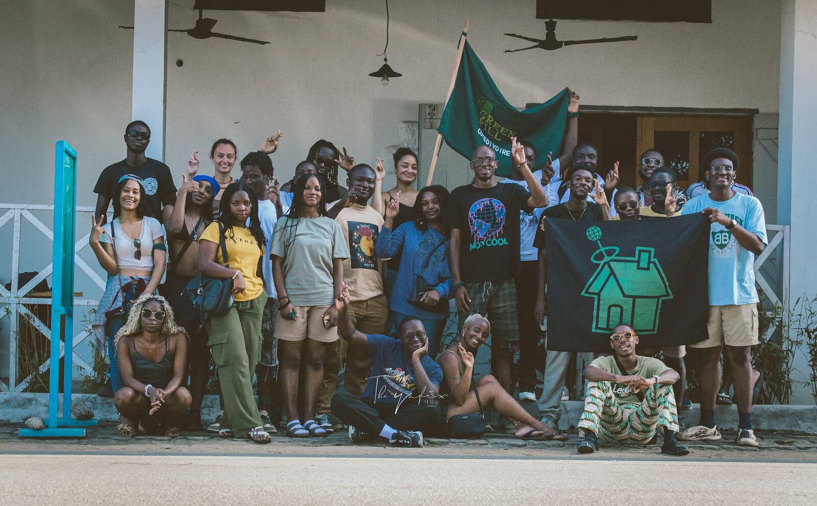 GreenPill Cote d'Ivoire community members gathered with chapter flags after a local activity.